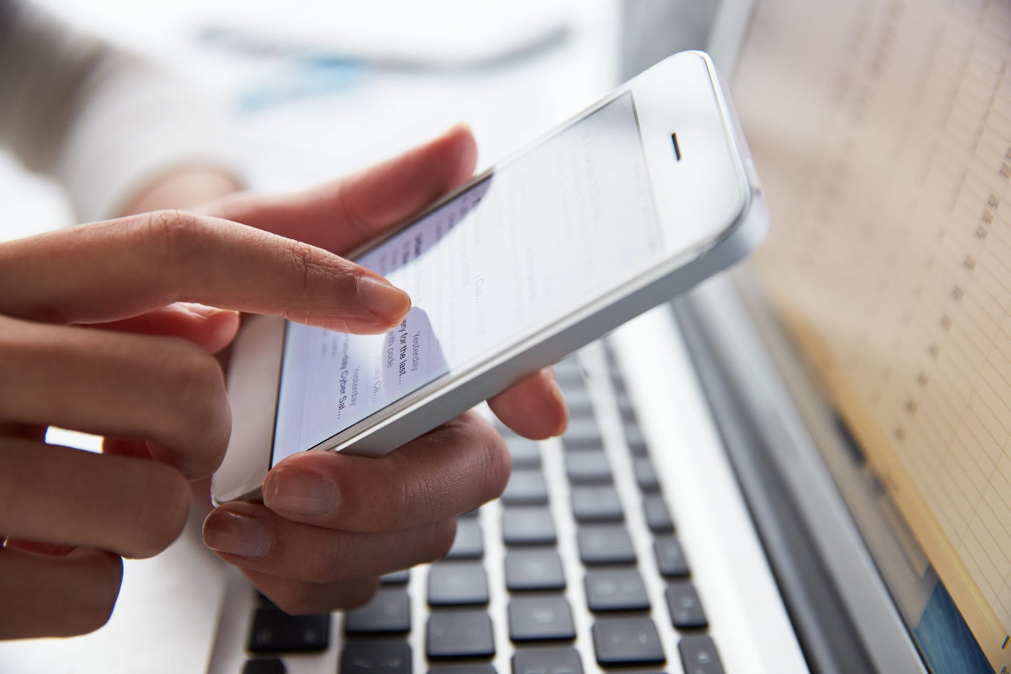 Photo of a woman's hand holding a cell phone, in front of a computer|Photo of a SafeSleeve cell phone radiation protection device