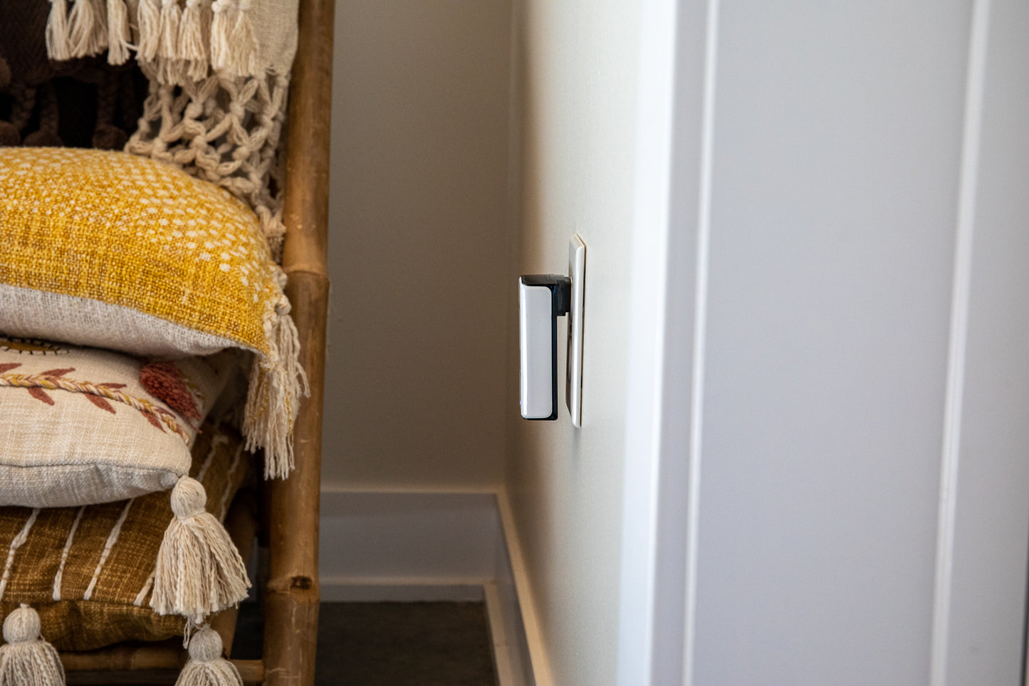 EMF PROTECTION - Phi 2 plugged into a white wall with a pile of pillows next to it