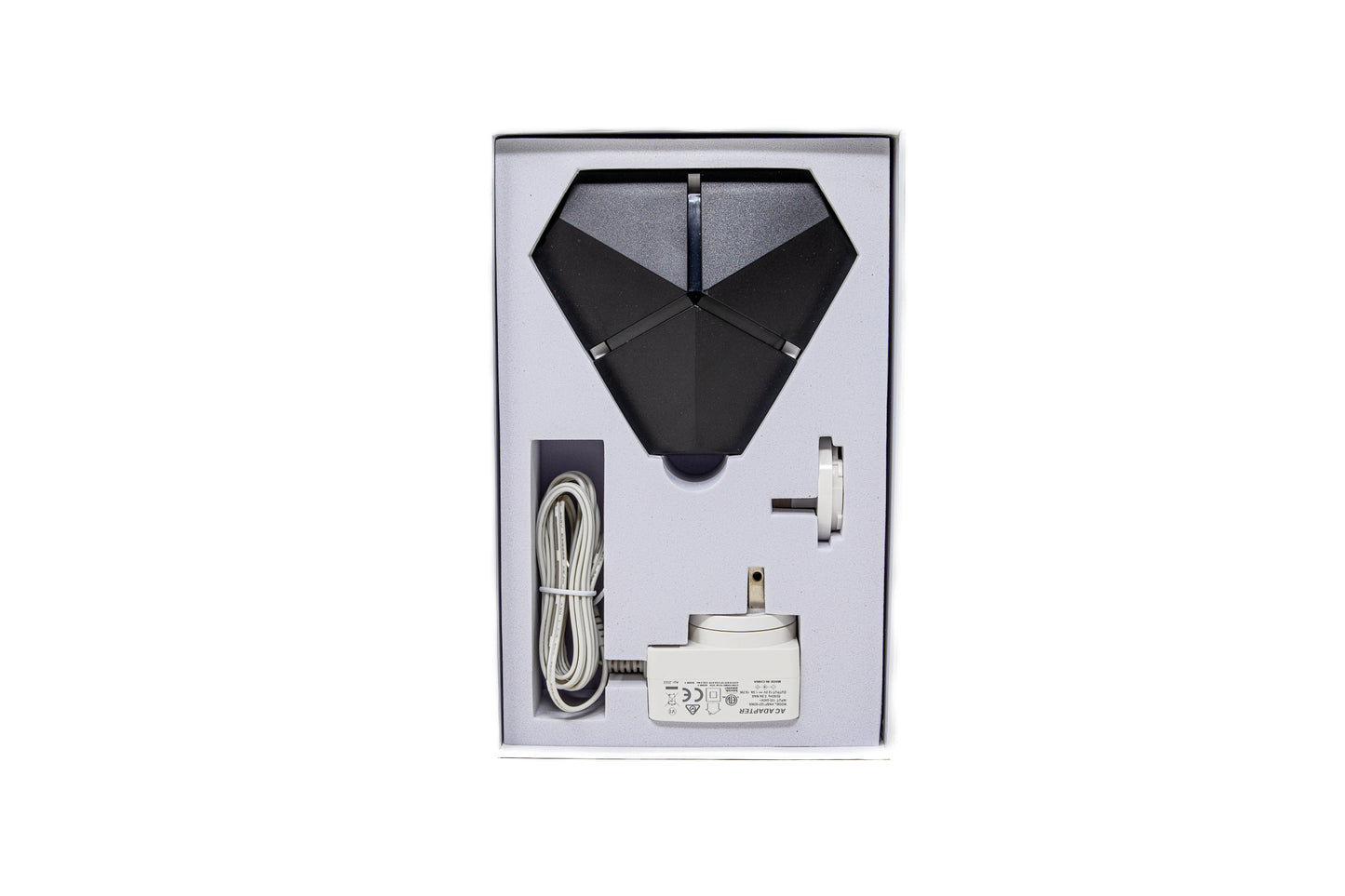 EMF PROTECTION  - Photo of Phi 03 with charger cord and plugs inside box