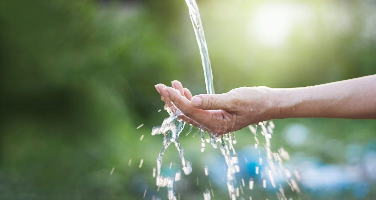 Image of a woman's cupped hand with water pouring into it